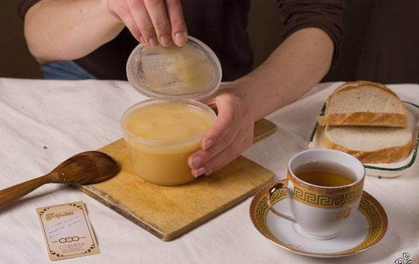  Rape honey in a plastic jar on the table